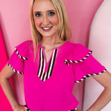 Neon pink flutter sleeve blouse with colorful striped neckline and sleeve trim.