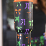 Bow Bewitched Tumbler with spooky bow print, reusable straw, screw-on lid, and handle.