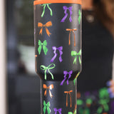 Bow Bewitched Tumbler with spooky bow print, reusable straw, screw-on lid, and handle.