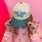 Leopard print bill cap with teal embroidered “Jesus Saves I Spend” phrase and adjustable strap.