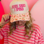 Floral bill canvas cap with pink embroidered “Jesus Saves I Spend” phrase and adjustable strap.