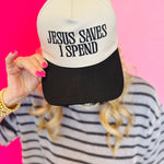 Black canvas cap with black embroidered “Jesus Saves I Spend” phrase and adjustable strap.