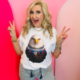 White graphic tee featuring jeweled eagle design with colorful patriotic accents on soft cotton fabric