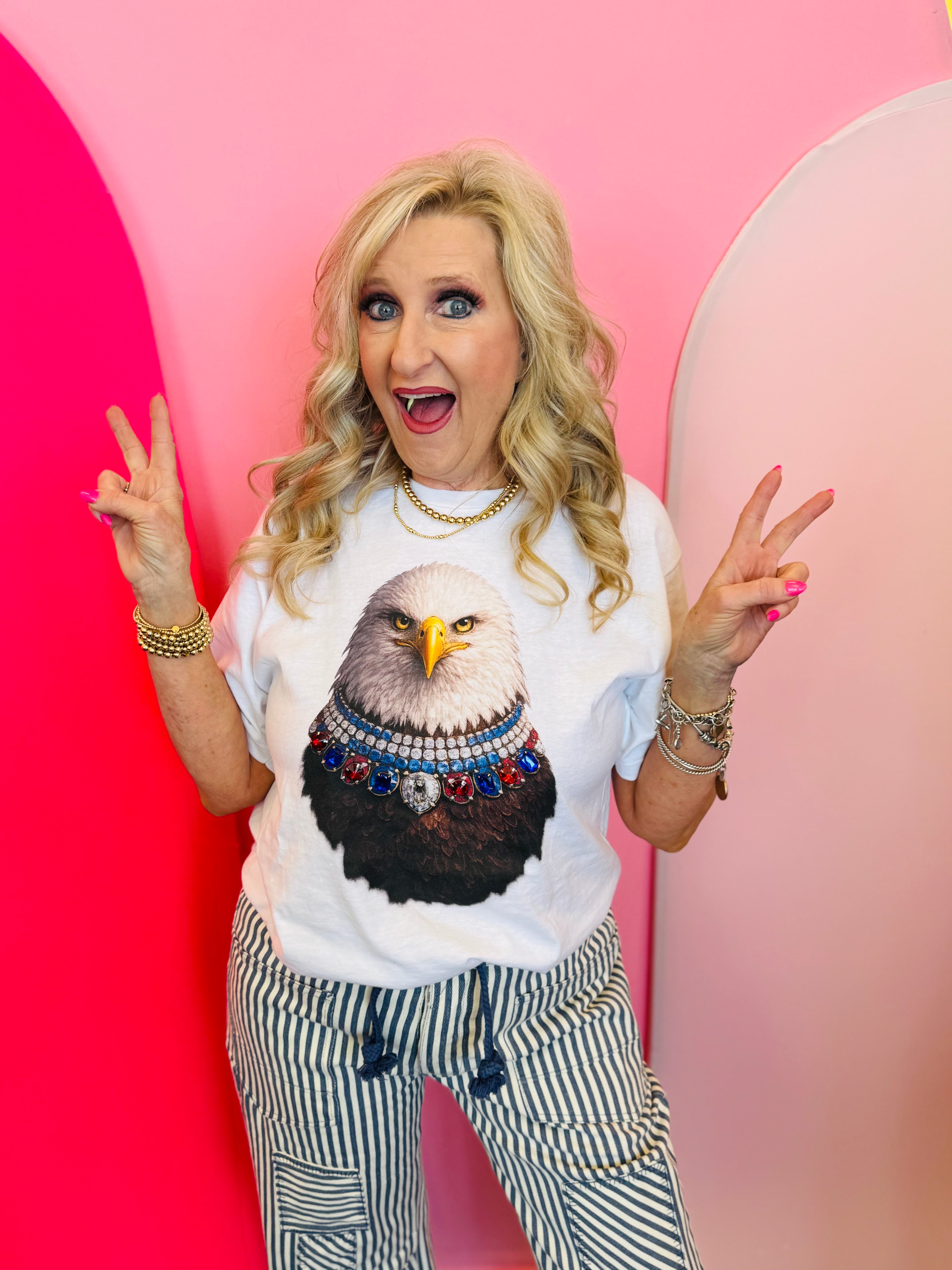 White graphic tee featuring jeweled eagle design with colorful patriotic accents on soft cotton fabric