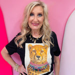 Black tee with white leopard patch and multicolored crystal necklace.