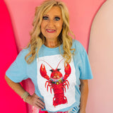 Blue collared tee with white lobster patch and short sleeves.