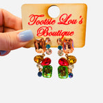 Multicolored gemstone statement earrings with peach top gem and cascading jewel cluster.
