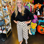 White wide-leg pants with black polka dots, hidden zipper closure, back stretch waistband, and side pockets.