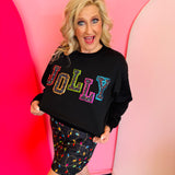 Black Jolly Patch Pullover with multicolor trim and festive light details shown from the front.