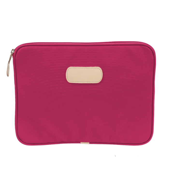 15" padded computer case in coated canvas with natural leather trim, zip closure, and padded interior.