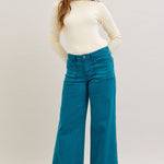 Teal Judy Blue wide-leg jeans with high rise, clean hem, and classic pockets.