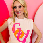 Light pink Just God tank with cropped fit and bold "JUST" integrated into the letter "G" of "GOD" in hot pink and orange.
