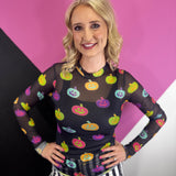 Sheer mesh Halloween top with colorful pumpkin print, mock neck, and long sleeves.