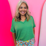 Kelly green corded rib knit top with relaxed fit and hi-low V-neck.