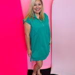 Kelly Green textured jacquard mini dress with quarter zipper neckline, side pockets, and high-low hem.