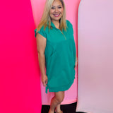 Kelly Green textured jacquard mini dress with quarter zipper neckline, side pockets, and high-low hem.