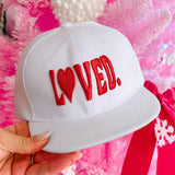 White LOVED embroidered baseball cap with heart detail and adjustable snapback closure