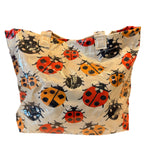 Ladybug tote bag with double handles, interior pockets, and Velcro closure.