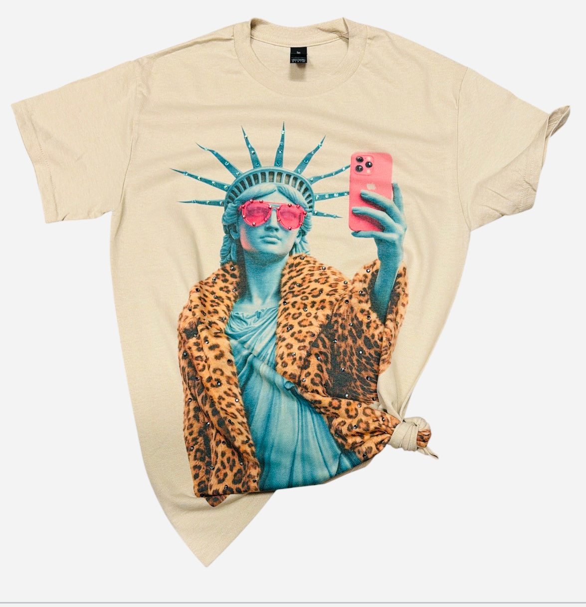 Cream Lady Liberty graphic tee with pink sunglasses, leopard coat, and rhinestone details.