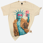 Cream Lady Liberty graphic tee with pink sunglasses, leopard coat, and rhinestone details.