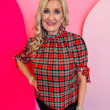 Red, green, and black plaid top with leopard accents, ruffled sleeves, and mock neckline.