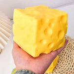 Large cheese wedge squishy stress toy with soft sensory texture.