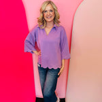 Lavender scallop top with V-neck, collared detail, and scalloped trim.