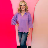 Lavender scallop top with V-neck, collared detail, and scalloped trim.