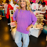 Lavender waffle knit top with boxy fit, raw seam, 3/4 sleeves, and longer back.