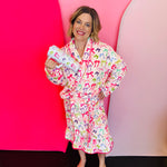 Daylight Bow robe with ruffle hem, long sleeves, and adjustable waist tie.