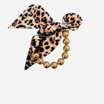 Gold beaded bracelet with leopard fabric bow detail.