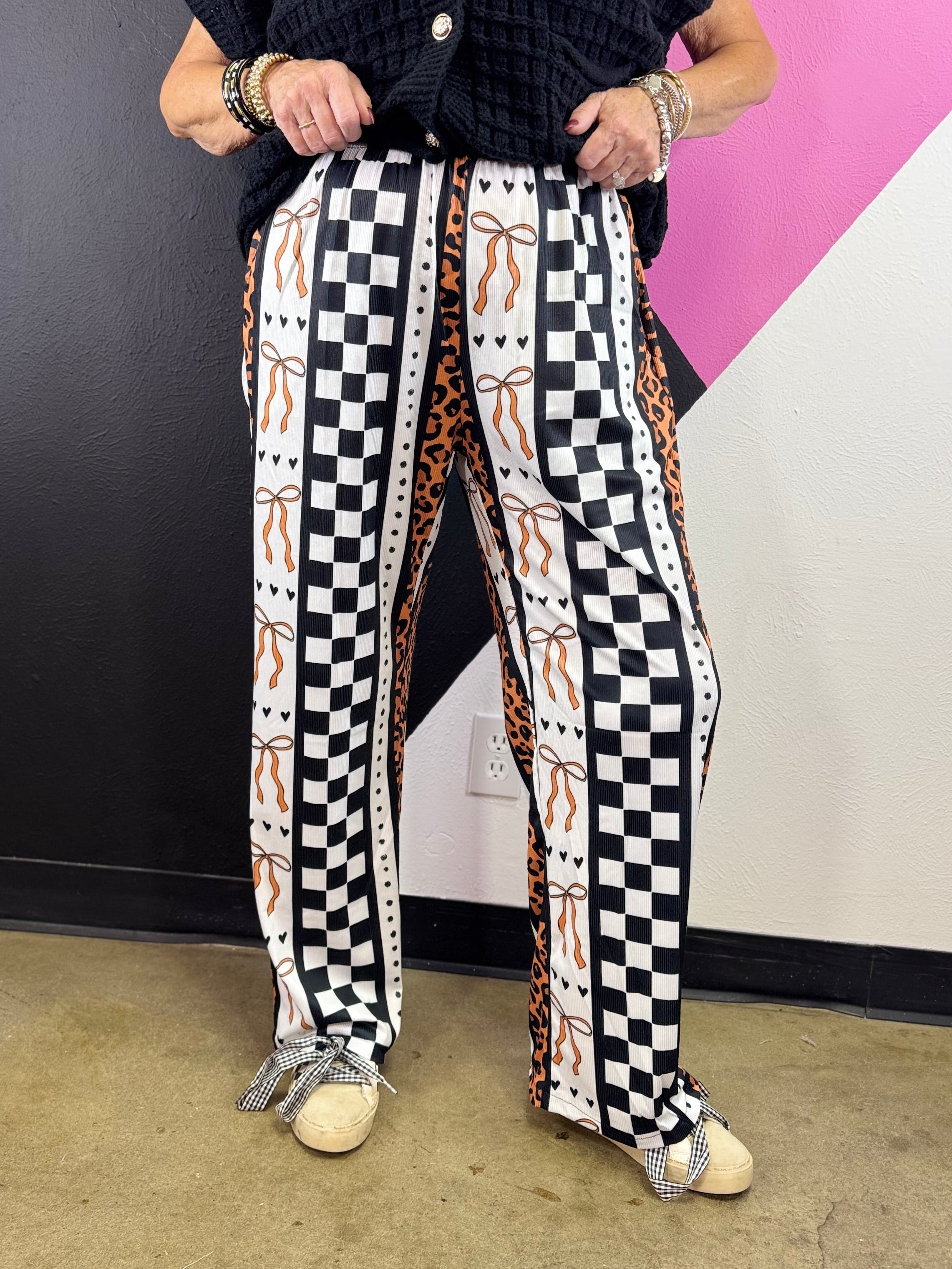 Orange leopard and black white checkerboard pants with bow details and vertical patchwork.