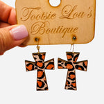 Leopard print cross dangle earrings in orange and black tones, lightweight and trendy design.