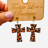 Leopard print cross dangle earrings in orange and black tones, lightweight and trendy design.