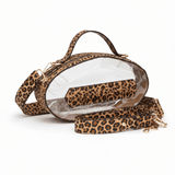 Leopard print football-shaped crossbody bag with gold hardware, top handle, and adjustable strap.