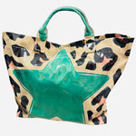 Leopard tote bag with bright green star detail and shiny finish.