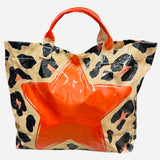 Leopard tote bag with bright orange star detail and shiny finish.