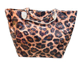 Leopard print PVC tote bag with glossy finish, sturdy handles, interior pockets, and Velcro closure.