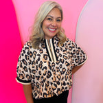 Leopard print top with striped zip collar and relaxed drop shoulder fit.