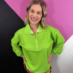 Neon green ribbed quarter zip pullover with collared neckline and gold-tone zipper.