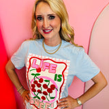 Light blue graphic tee with cherry design and life is sweet lettering