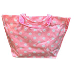 Light pink PVC tote bag with white polka dots, darker pink sides, and sturdy handles.