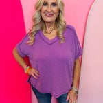 Light plum corded rib knit top with hi-low V-neck and short sleeves