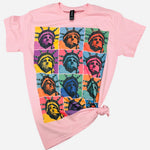 Soft pink Lady Liberty graphic tee with colorful retro artwork and rhinestone accents.