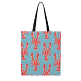 Blue tote bag with vibrant orange lobster print and sturdy cream handles