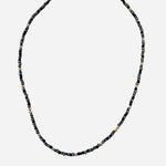 Gold filled necklace with black and grey beads and gold accents.