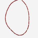 Gold filled necklace with red beads and gold accent details.