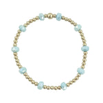 Gold filled beaded bracelet with blue frosted crystals and stretch fit design.