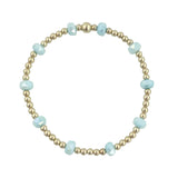 Gold filled beaded bracelet with blue frosted crystals and stretch fit design.