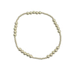 Gold filled patterned beaded stretch bracelet with mixed bead sizes.